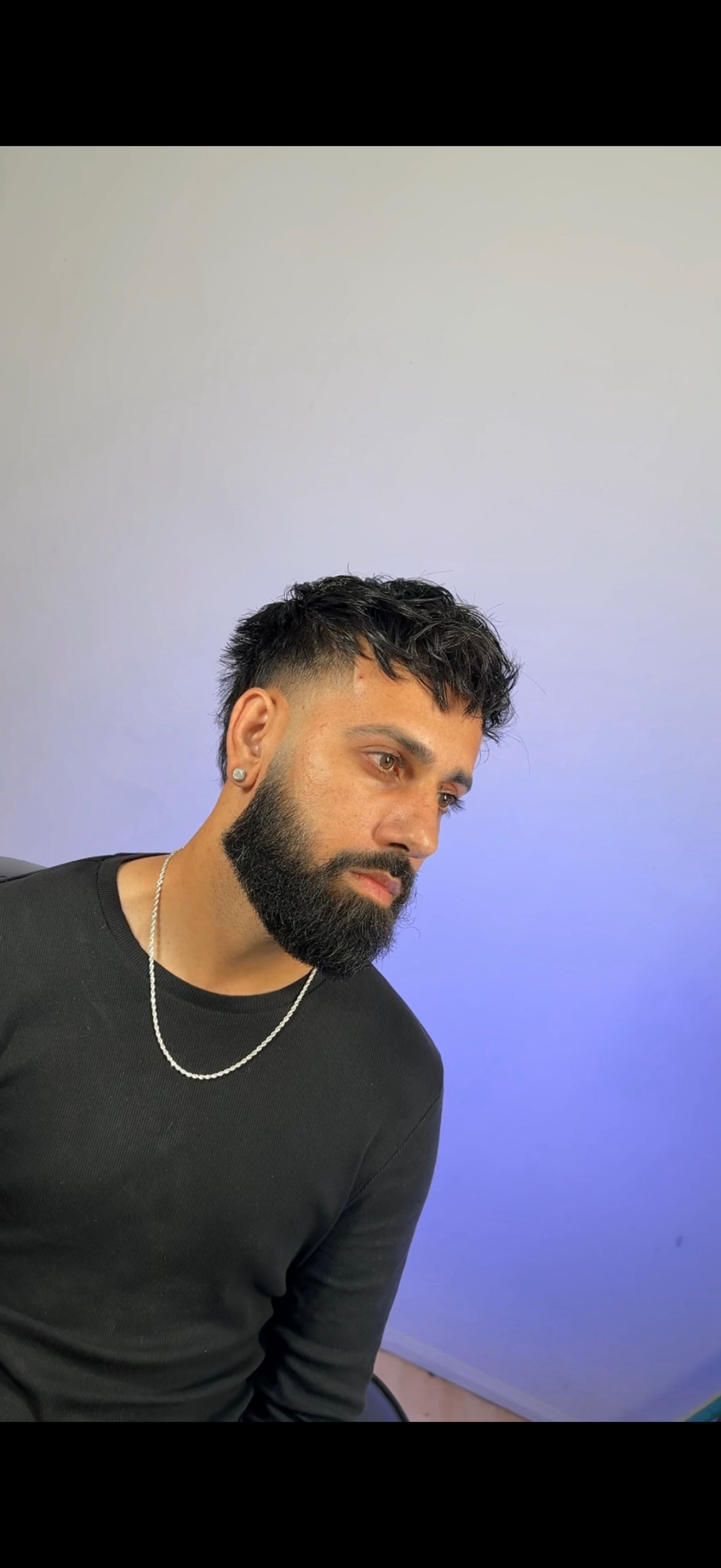 Textured fringe with a sharp low fade and full beard